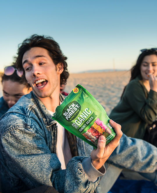 Group eating gummy candy at the beach