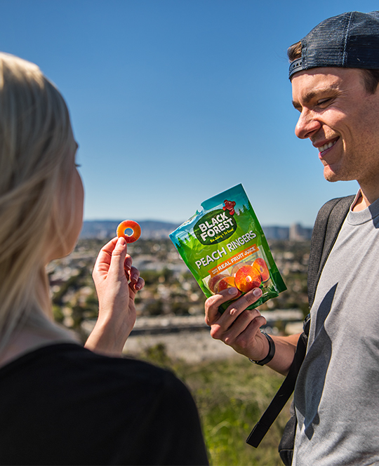 People hiking and eating peach ringers
